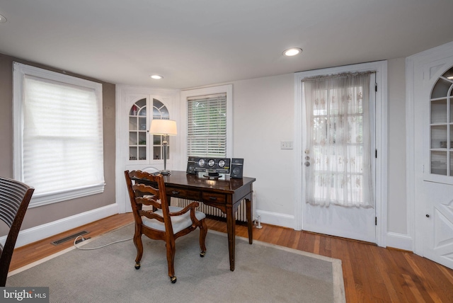 dining room with baseboards, visible vents, and wood finished floors