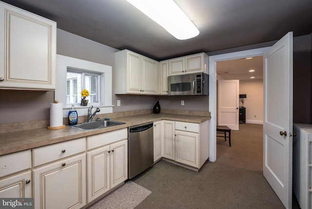 kitchen featuring a sink, light countertops, appliances with stainless steel finishes, dark colored carpet, and recessed lighting