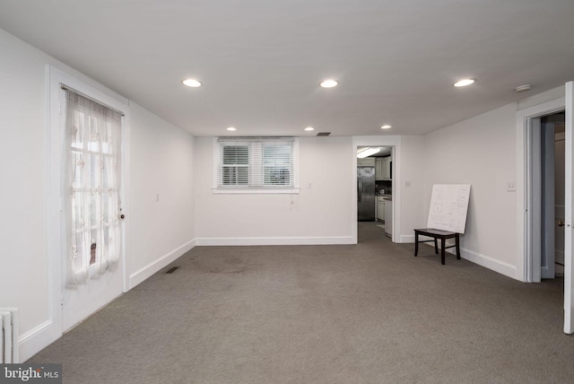 interior space with stainless steel fridge, recessed lighting, and carpet floors