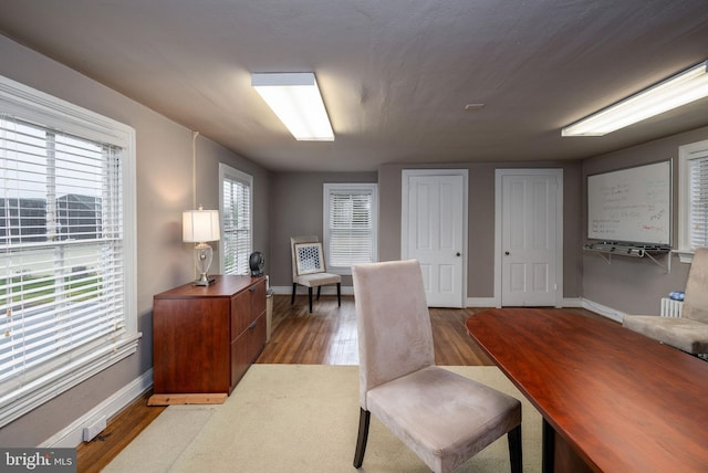 office space featuring baseboards and wood finished floors
