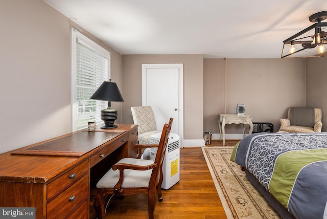 bedroom featuring baseboards and wood finished floors