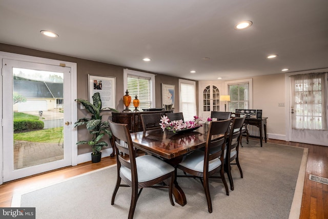 dining room with baseboards, light wood-style flooring, and recessed lighting