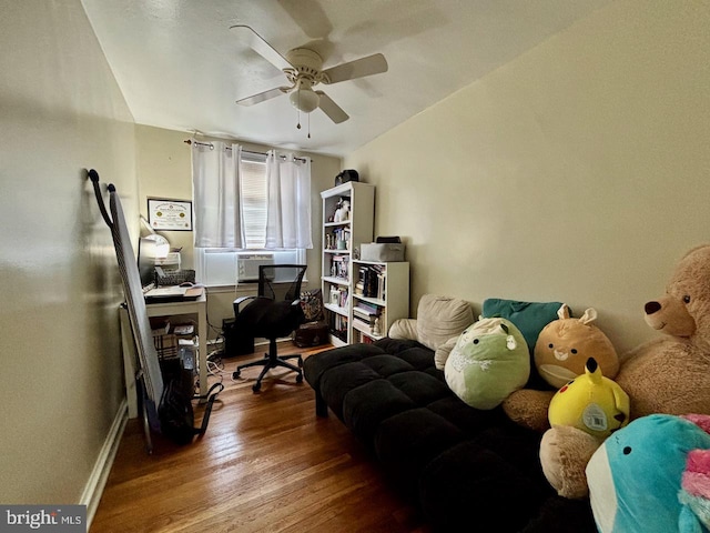 office space featuring ceiling fan, wood finished floors, cooling unit, and baseboards