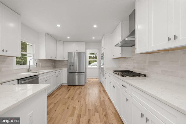 9828 Watts Branch Dr, Rockville, MD 20850 - kitchen featuring stainless steel appliances, wall chimney range hood, a sink, white cabinetry, and recessed lighting