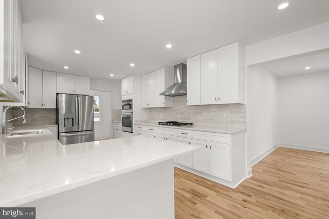 9828 Watts Branch Dr, Rockville, MD 20850 - kitchen with appliances with stainless steel finishes, a sink, wall chimney exhaust hood, recessed lighting, and backsplash