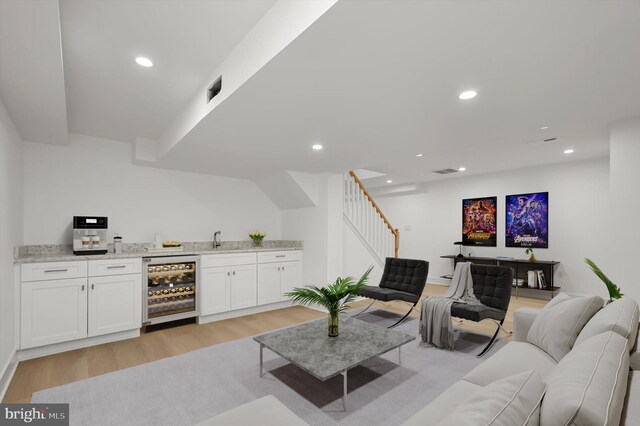 9828 Watts Branch Dr, Rockville, MD 20850 - living room with beverage cooler, wet bar, light wood-style flooring, stairway, and recessed lighting