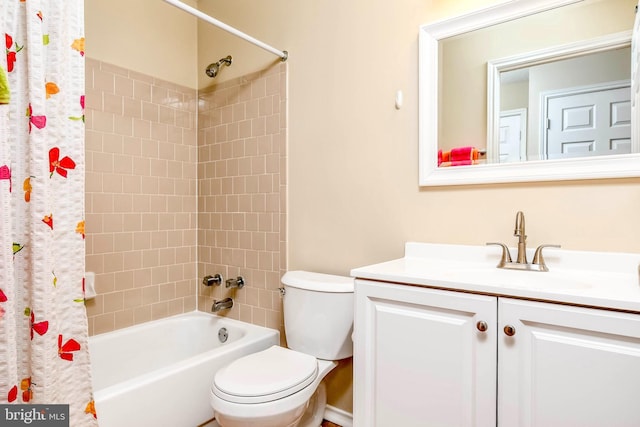 full bathroom featuring toilet, shower / tub combo with curtain, and vanity