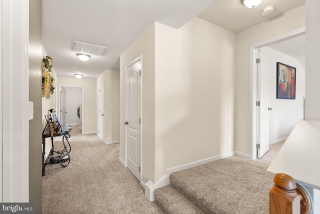 13859 Barrymore Ct, Gainesville, VA 20155 - corridor with light colored carpet, washer / dryer, and baseboards