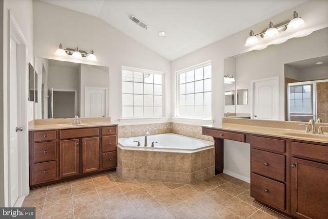 13859 Barrymore Ct, Gainesville, VA 20155 - bathroom featuring lofted ceiling, plenty of natural light, a bath, a stall shower, and two vanities