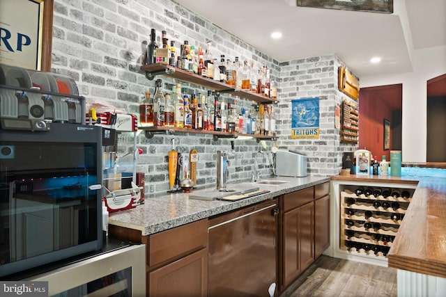 13859 Barrymore Ct, Gainesville, VA 20155 - indoor wet bar featuring light wood-style flooring, stainless steel dishwasher, wine cooler, and recessed lighting