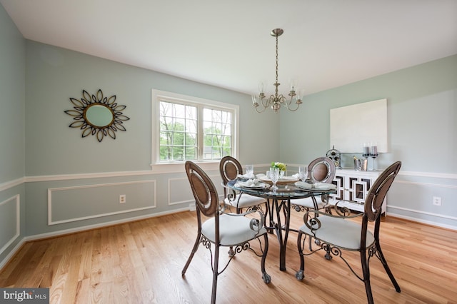 dining area with a chandelier and light wood-style flooring