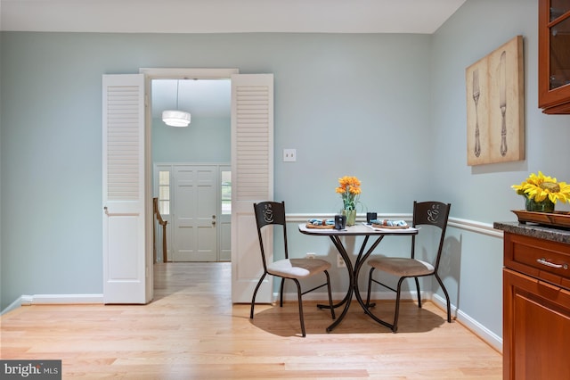 dining room with light wood-style flooring and baseboards