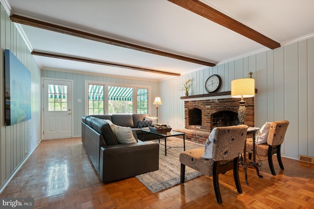living room featuring ornamental molding, beamed ceiling, and a brick fireplace