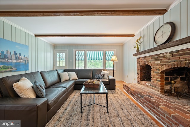 living area featuring a fireplace, crown molding, wood walls, and beamed ceiling