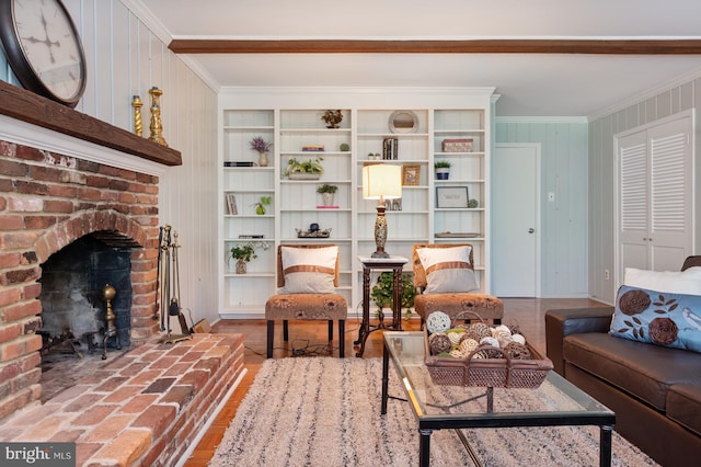 living room with crown molding and a fireplace