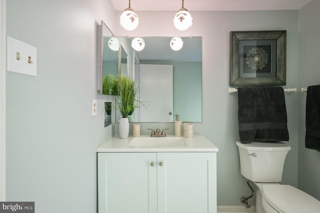 bathroom featuring toilet and vanity