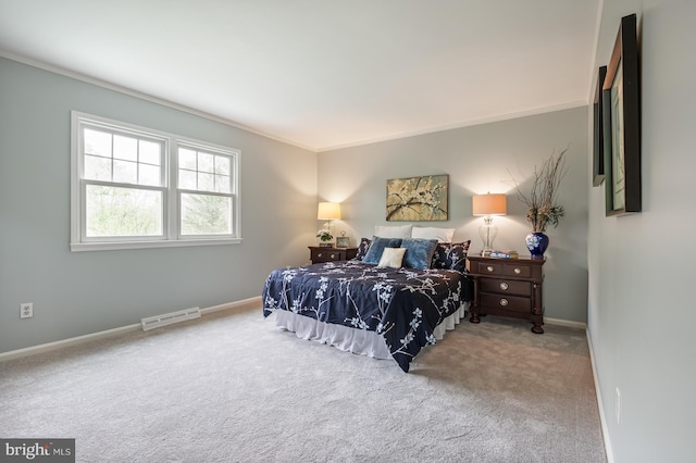 bedroom with crown molding, carpet, baseboards, and visible vents