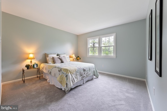 carpeted bedroom with baseboards