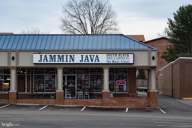 view of building exterior featuring uncovered parking