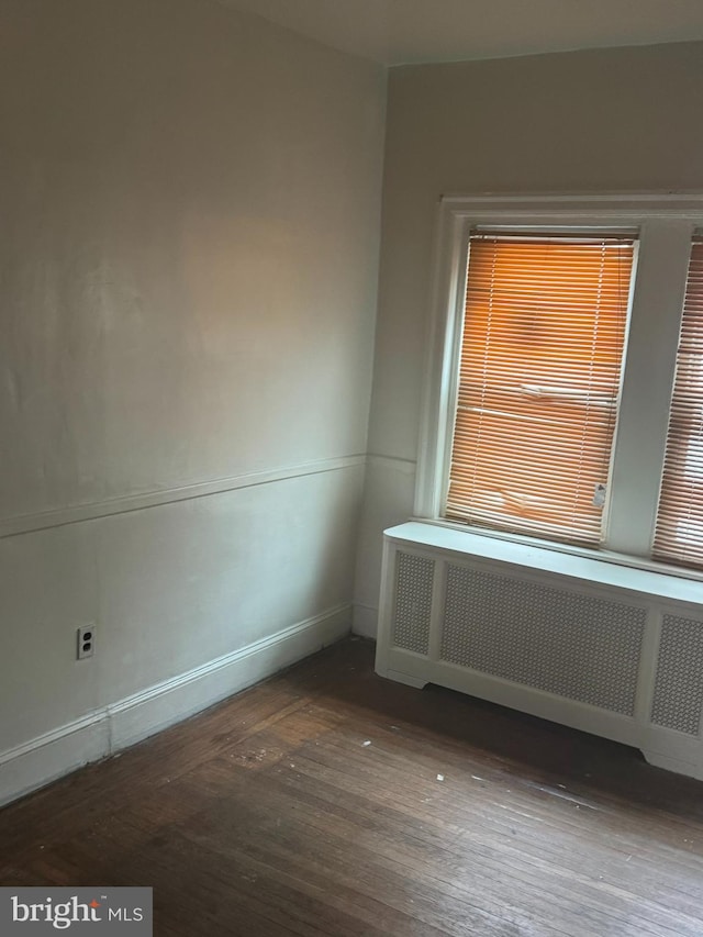 235 E Price St, Philadelphia, PA 19144 - empty room with radiator and wood finished floors