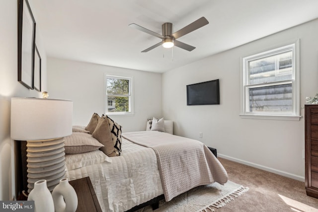carpeted bedroom with baseboards and ceiling fan