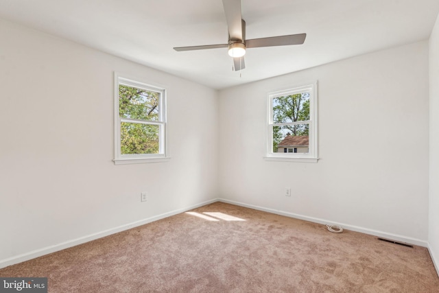 spare room featuring carpet floors, baseboards, and ceiling fan