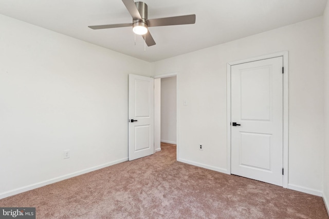 unfurnished bedroom with carpet, baseboards, and ceiling fan