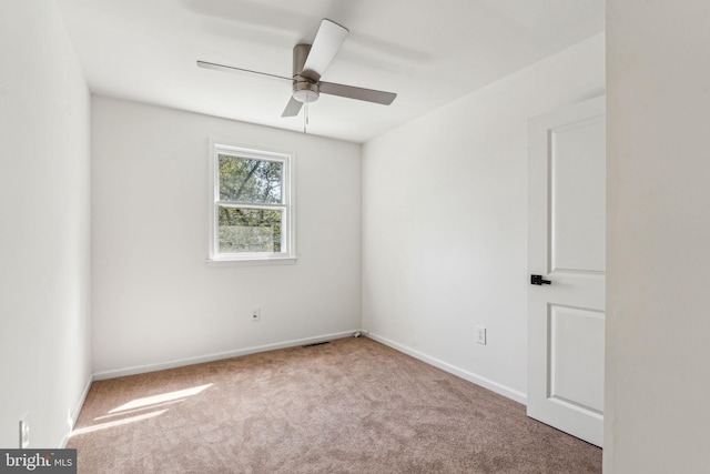 spare room featuring carpet flooring, a ceiling fan, and baseboards