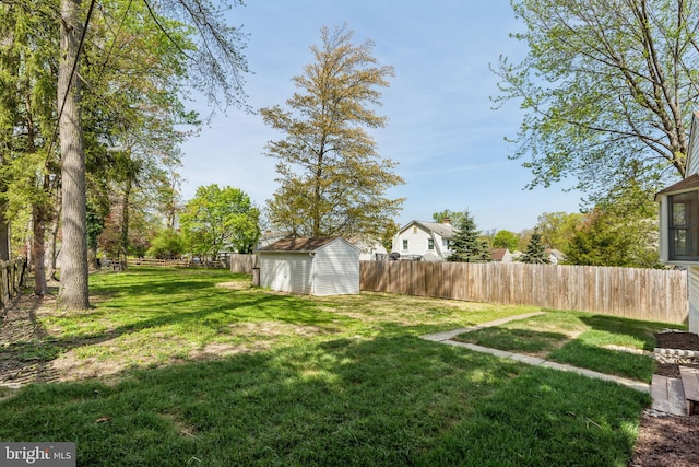 view of yard featuring a storage shed and an outbuilding