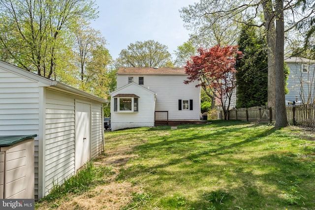 rear view of house with an outbuilding and a wooden deck