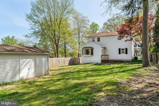 back of property featuring an outbuilding, a deck, and a storage shed