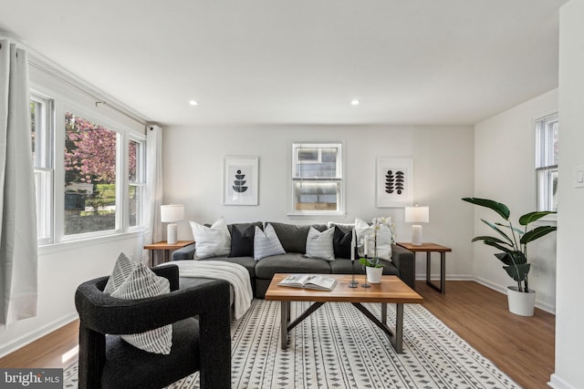 living room with wood finished floors, plenty of natural light, recessed lighting, and baseboards