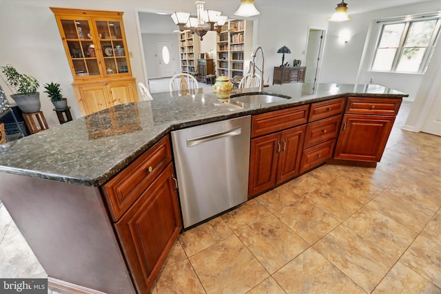 kitchen with dishwasher, a sink, hanging light fixtures, a chandelier, and dark stone countertops