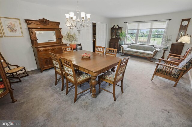 carpeted dining space with a chandelier