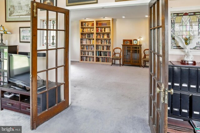 sitting room featuring french doors and carpet flooring