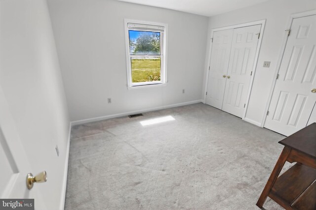 unfurnished bedroom with carpet floors and baseboards