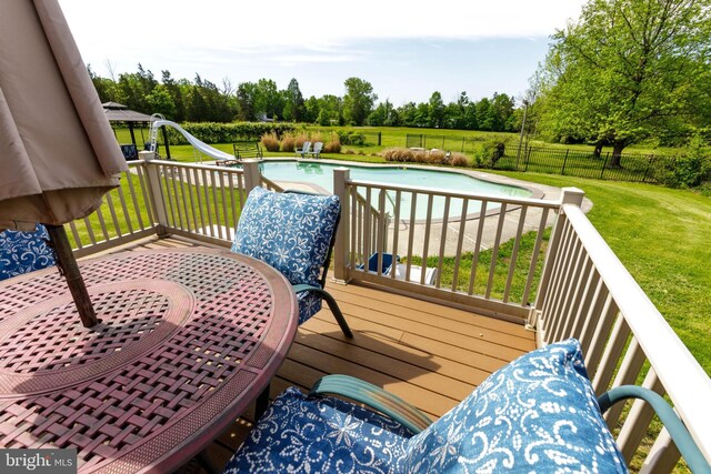 wooden deck with view of wooded area