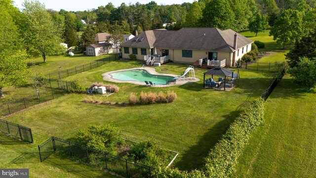 aerial view of property and surrounding area featuring a pool area