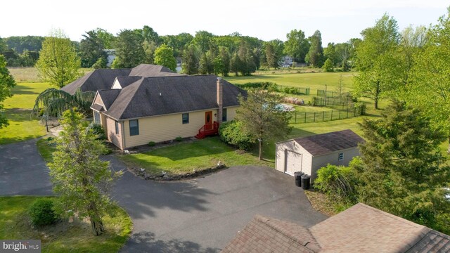 aerial view of property and surrounding area with a tree filled landscape