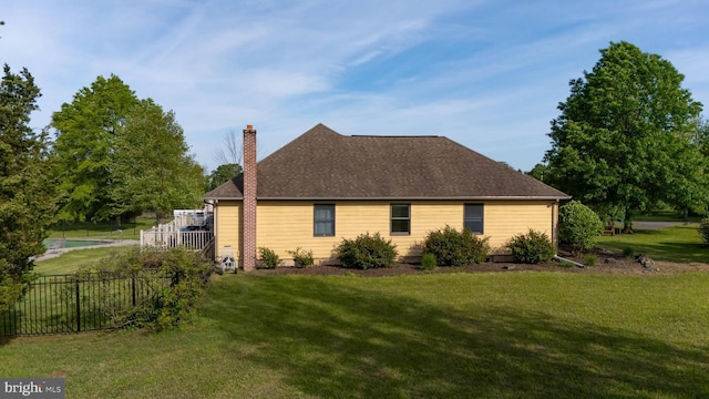 view of property exterior featuring a chimney and roof with shingles