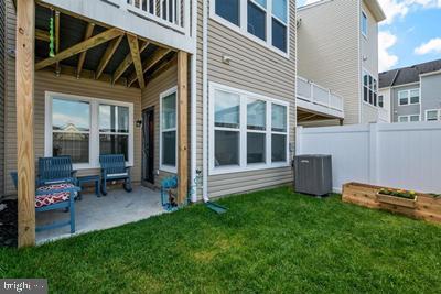 2038 Twisted Oak Pl, Hanover, MD 21076 - back of property with a yard, central air condition unit, a patio, and fence