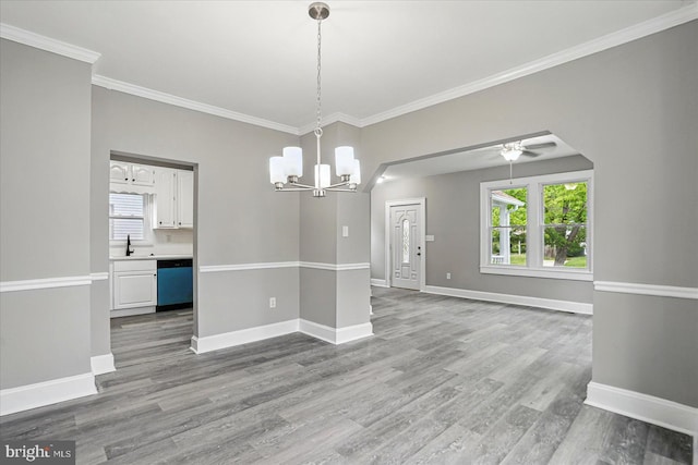 4911 Fox St, College Park, MD 20740 - unfurnished dining area featuring crown molding, plenty of natural light, and wood finished floors