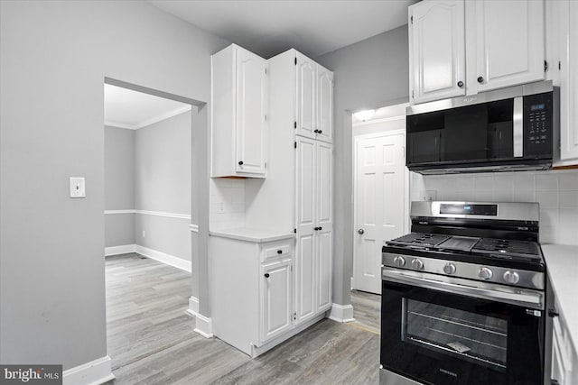 4911 Fox St, College Park, MD 20740 - kitchen with baseboards, light countertops, stainless steel appliances, and white cabinets