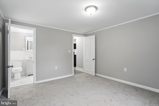 4911 Fox St, College Park, MD 20740 - unfurnished bedroom featuring crown molding, connected bathroom, and carpet floors