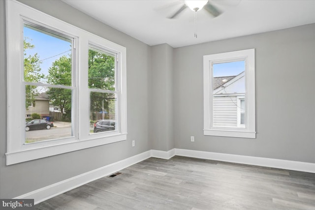 4911 Fox St, College Park, MD 20740 - unfurnished room with baseboards, a wealth of natural light, visible vents, and wood finished floors
