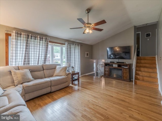 730 Cheryl Dr, Warminster, PA 18974 - living room with a ceiling fan, vaulted ceiling, light wood-type flooring, stairs, and a glass covered fireplace