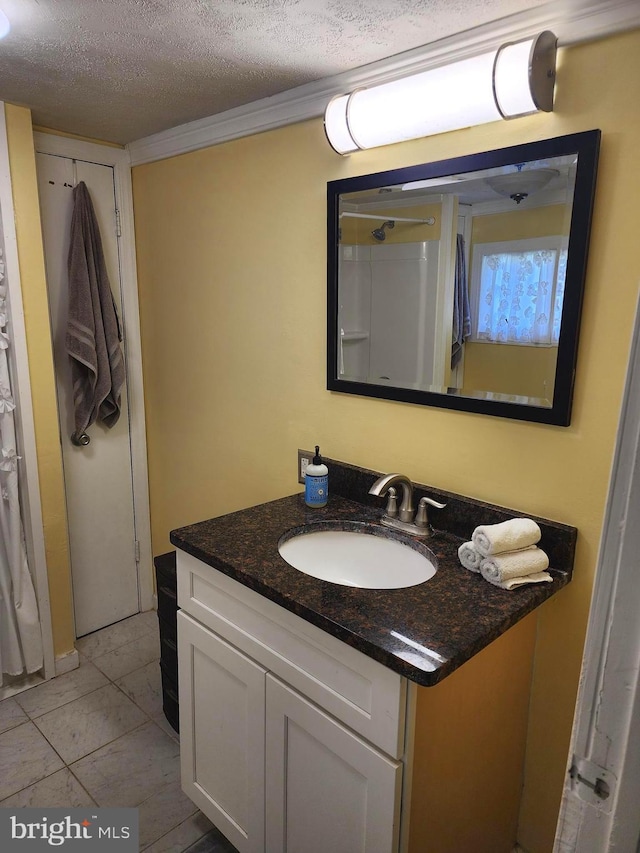 bathroom featuring a textured ceiling and vanity