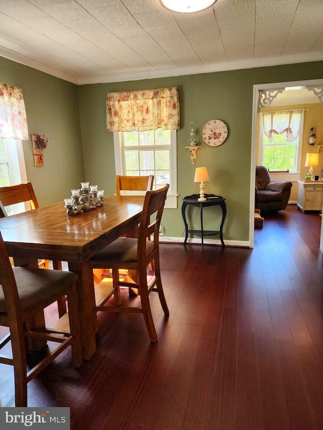 dining room featuring crown molding and dark wood finished floors