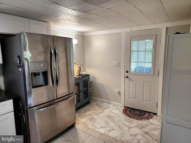 kitchen featuring white cabinets, ornamental molding, marble finish floor, and stainless steel refrigerator with ice dispenser
