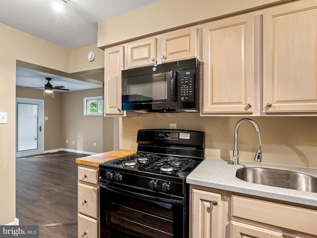 kitchen featuring black appliances, light brown cabinets, ceiling fan, and a sink